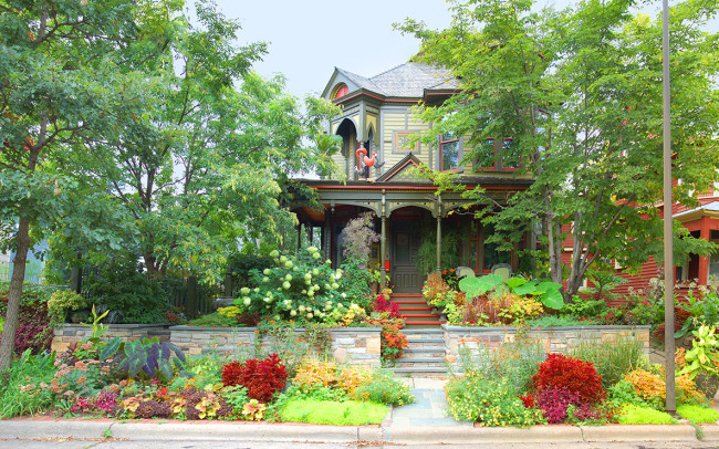 This newly gorgeous Queen Ann house sits in harmony with its lush and wildly colorful garden surroundings, bordered by a multi-colored stone wall and stairs. Together they offer a feast for the eyes on even the cloudiest of days.