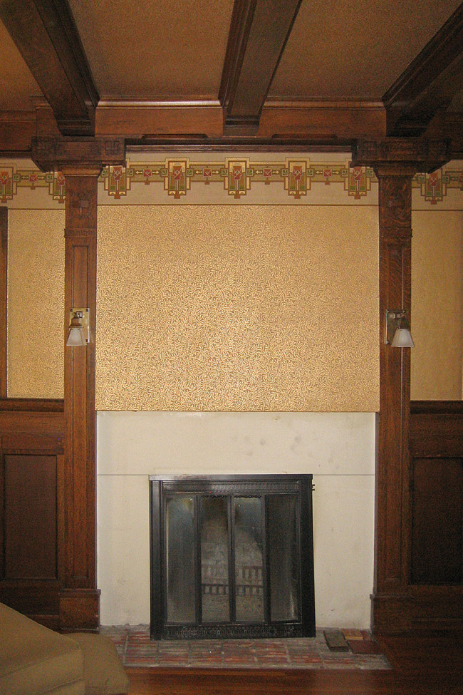 Step 1 The pre-restoration fireplace - botanic gold and ivory wallpapered sheetrock above and a very plain white marble surround below with a black metal built-in screen. Modern and not fitting in with the rest of the room.