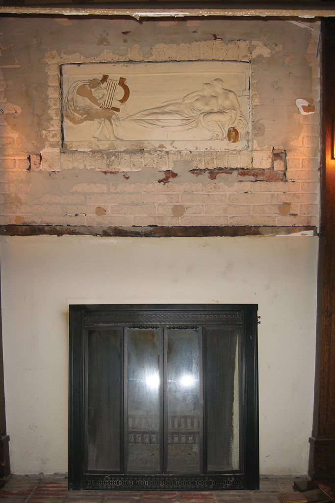 Step 2 With the sheetrock removed, the original, damaged plaster frieze and brick are revealed.