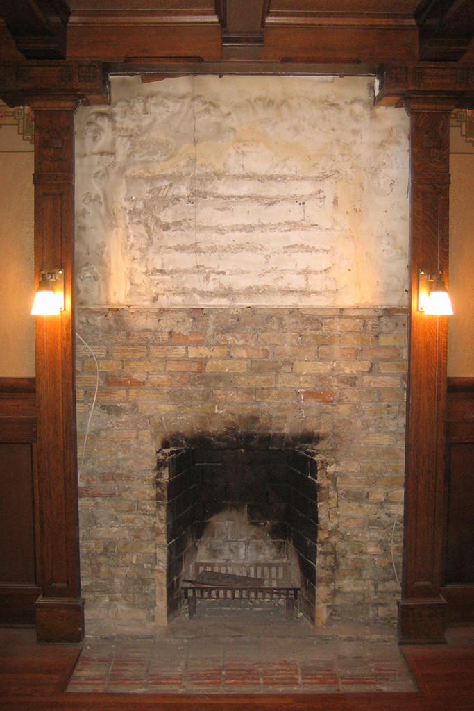 Step 4 The frieze has been carefully removed, as has the marble and screen, and the original, damaged brick chimney breast is completely exposed.