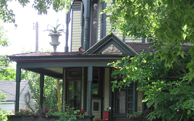 Before, the house was painted in three colors - a pale green for the main color, with most of the trim in a much darker bluish gray, and orange-red for the accents.