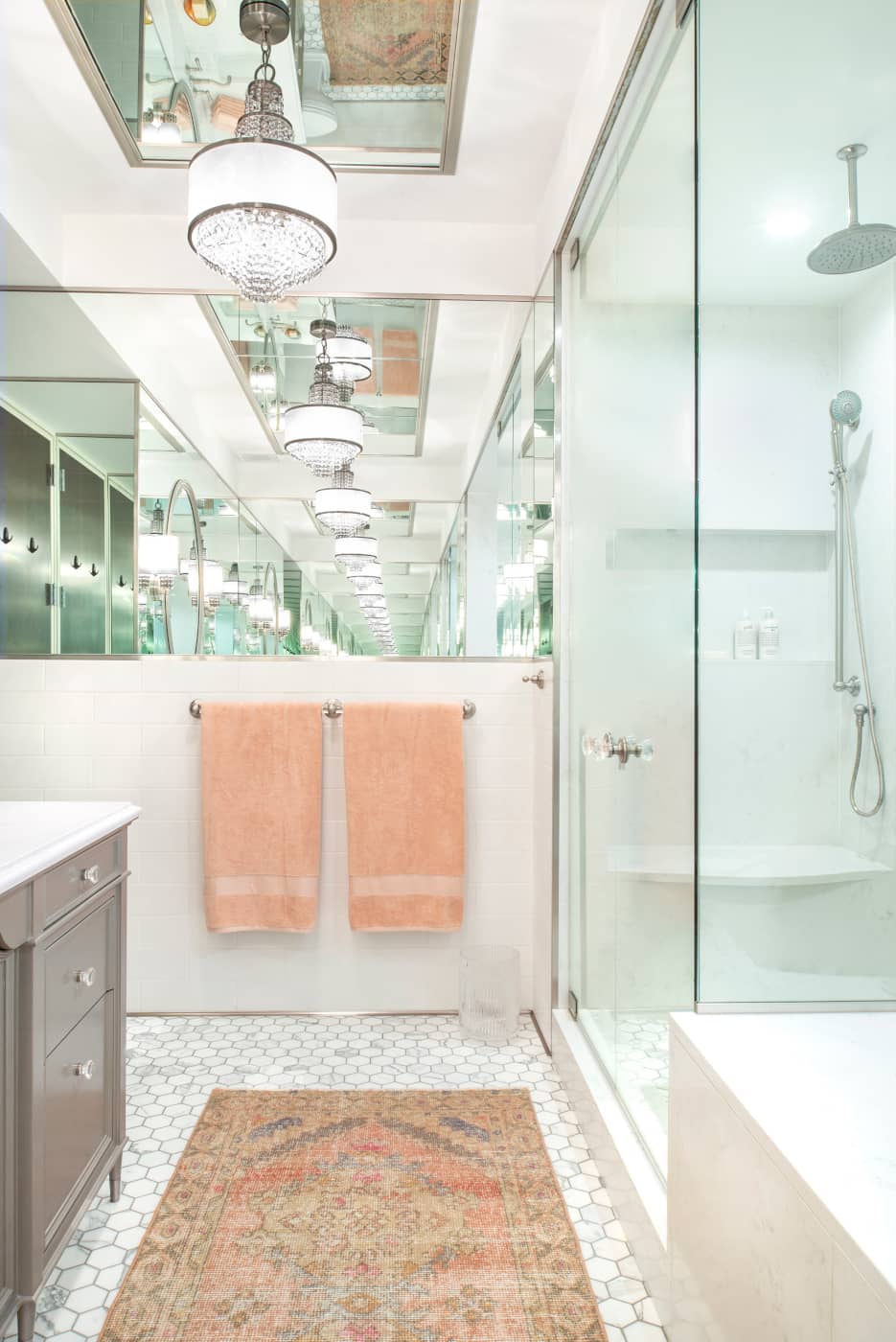 Because of the multitude and placement of the mirrors, you get an infinity mirror effect, reflecting the bathroom's luxurious details again and again and again.